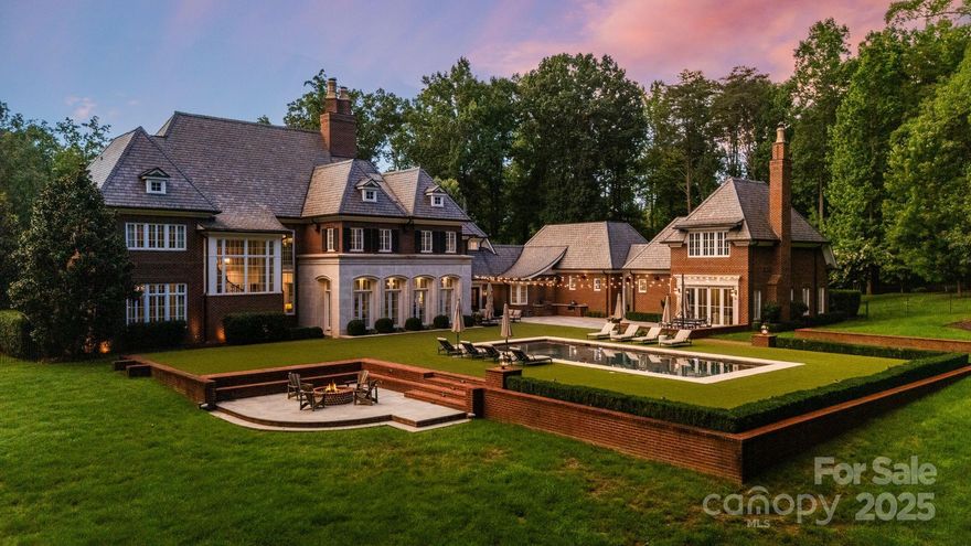 A crown jewel of Lake Norman, this 33-acre private estate offers a once-in-a-lifetime blend of land, lake, and luxury just off Brawley School Road. Designed by renowned architect Harry Schrader and crafted by Arcadia Homes in 2015, the nearly 9,000 sq. ft. residence is a showcase of timeless architecture, soaring spaces, and uncompromising quality. Behind the gates, manicured grounds and wooded privacy unfold into a rare sanctuary with direct lake frontage and a private dock. The main home is complemented by a detached pool house and resort-style pool with turf surround, creating the ultimate retreat for relaxation and entertaining. Properties of this scale, privacy, and architectural distinction are rarely available. This is truly a once-in-a-lifetime opportunity to own one of Lake Norman’s most remarkable estates.
