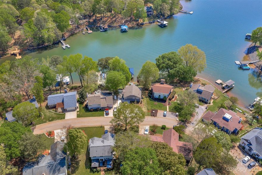 Absolutely STUNNING, RENOVATED, WATERFRONT HOME IN TEGA CAY AREA! Spacious Living Room with expansive Lakeview, Formal Dining Room, Open Kitchen,1 Bedroom/Office with a Full Bath on Main Level. Master Suite w/sitting area w/ extensive windows and breathing views of the lake is on the lower level with a private bath. Bedrooms 3&4 share a Full Bath also on the lower level. Expansive New Deck overlooking Lake Wylie with a Newly built private Covered Dock with plenty of room for your jet skis/boats. No HOA! Enjoy Tega Cay's Amenities & lifestyle. The community has a golf course/clubhouse, waterfront pool, and fitness facility along with outdoor areas: a park, athletic fields, playground & community marina. UPGRADES: Freshly Painted, NEW Dock, Deck, Flooring, Baseboards, Harding Cement Siding, Stair Rails inside and outside the property, Doors, Gutters, Roof, Kitchen & Bathrooms were completely renovated w/New Quartz Countertops, New Cabinets, New Fixtures, New Appliances + a New Driveway.