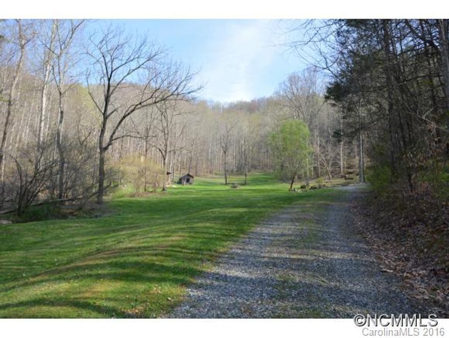 Your peaceful, beautiful 40 acre cove has a very open feel yet it is very private and is bordered on 3 sides by ridges. It has the serenity you desire, yet you are only 25 minutes from the heart of downtown Asheville. It has multiple, running spring branches. The gentle, lush green area awaits your picnics and get togethers this spring. The original, dry-stack, stone fireplace from now gone farm house is to one side of small pavilion. The low, open area and ridges have pleasant views. Call now!