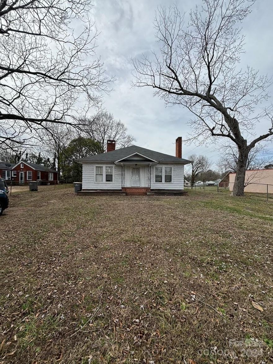 Perfect investor opportunity! This home was a single family home, converted to a duplex, and now back as a single family home. Best use would be a duplex. Already has two driveways. A fireplace is on each side and have been sealed off. Conditions unknown. Home has two water heaters. One is newer than the other. Per seller, original wood oak floors are under the floor coverings. Back yard is partially fenced in. The potential is limitless!