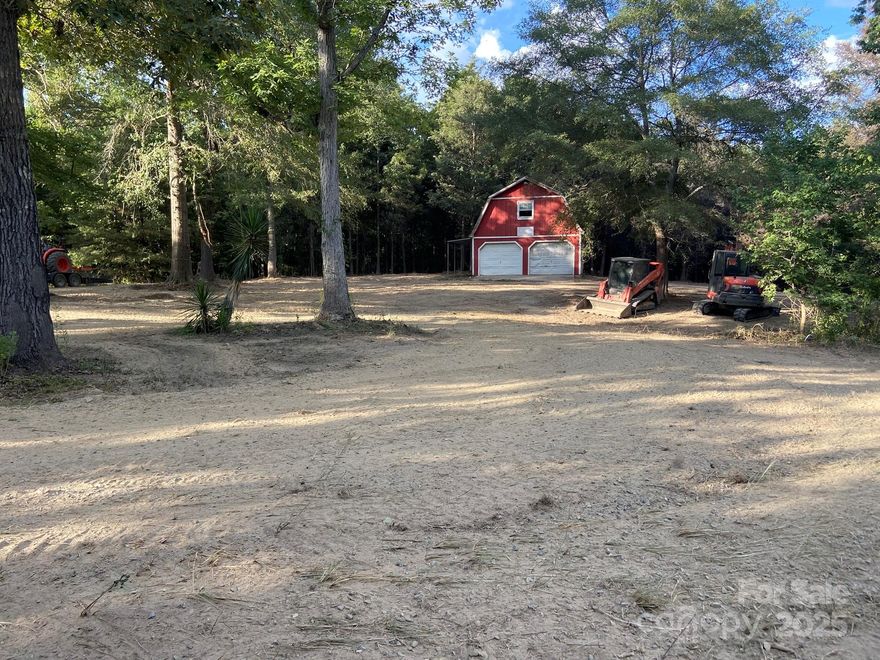 Discover the potential of this expansive 7.03-acre residential lot in the serene subdivision of Edgemoor, South Carolina. Situated at the end of a peaceful cul-de-sac, the property offers a level, cleared building site ready for your custom home, enveloped by mature trees for added privacy and natural beauty. An existing barn provides versatile storage or workshop space, while septic and well systems are already installed (buyer to verify condition and functionality). Conveniently located approximately 10 miles from Rock Hill, 16 miles from Chester, 23 miles from Lancaster, and 34 miles from Charlotte, NC, this is an ideal canvas for your dream retreat in Chester County.