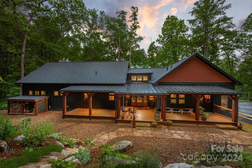 Custom-built Craftsman-style home offers an exceptional living experience with modern luxury, comfort, privacy, & seclusion just 18 minutes from downtown Asheville. Living, dining, & kitchen areas are combined into an open space with 10-ft ceilings, rich hardwood floors & high-end finishes throughout. Chef's kitchen with island, chef's pantry with fridge & copper bar sink. Sophisticated outdoor spaces are an invitation to linger. The primary suite features a walk-in closet, laundry & full bath. 2nd primary boasts a separate entrance, vaulted ceilings, mini-fridge, & ensuite bathroom. Daylight basement w Pella sliding glass doors & 9-ft ceilings is a haven for relaxation & entertainment, featuring a workshop with a utility sink & French doors & a bonus room plumbed for a 3rd bedroom. If you dream of main-level living with ample, level parking, convenient to hospitals, groceries, & more, this tranquil wooded retreat is a must-see! Direct access to the Mountains-to-Sea hiking trail.