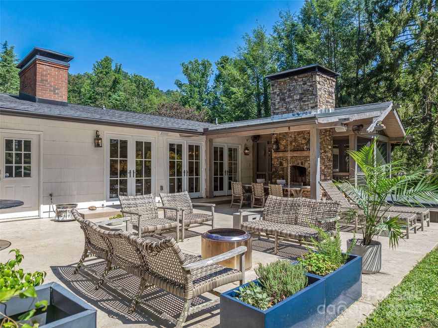 Don't miss this quintessential North Asheville remodeled and redesigned contemporary ranch style home. Enjoy this great location that backs up to the Country Club of Asheville Golf Course and is within an easy walk to the clubhouse. Wow, they thought of everything, will be your first thought when you walk in and see the open space with highly designed finishes and wall of French doors that bring the outdoor living room inside. Entertaining will be a pleasure in the open floor plan and custom kitchen with Thermador appliances, cleverly hidden outlets and rollout shelving. The primary suite is well appointed and walks out onto a private screened porch with a stone fireplace and ample room to relax or start your day. The bath has an oversized tub and beautiful walk-in shower, Carrara marble counters and accents. There are two additional ensuite bedrooms on the main level and a stylish powder room as well. The fully finished lower level has a full bath, bonus/theater room, built-ins and Jotul wood stove.