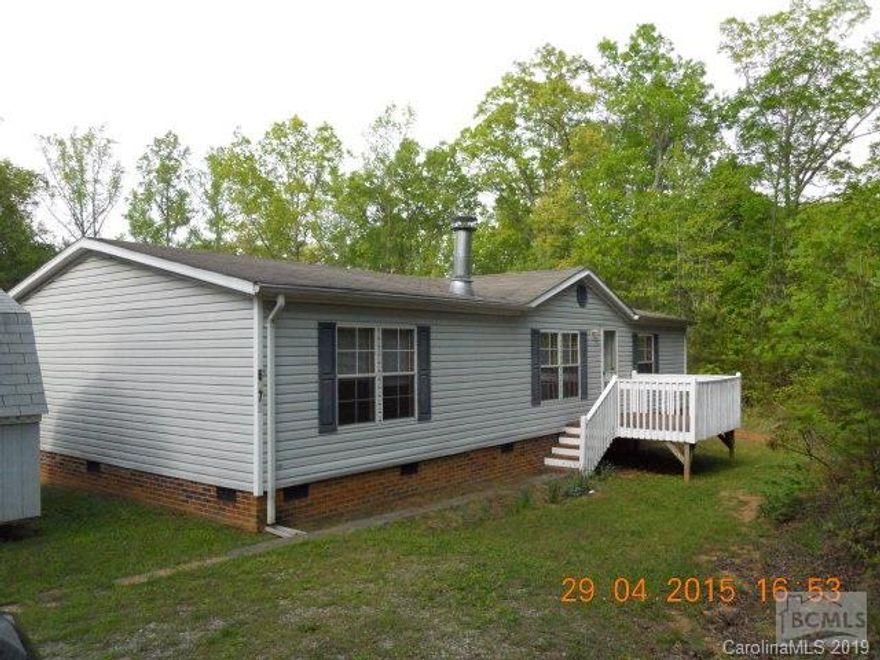 Immaculate 3 bdr/2 bath double-wide home situated on 1 acre nestled and bounded by lots of trees offering plenty of privacy. There's a wood-burning fireplace in the huge living area.  The kitchen is an open design and offers lots of cabinetry.  The home features a split bedroom design.  The master bath has a huge garden tub and a stand-alone shower.  This is a great opportunity to buy a home in move-in condition at a great value!