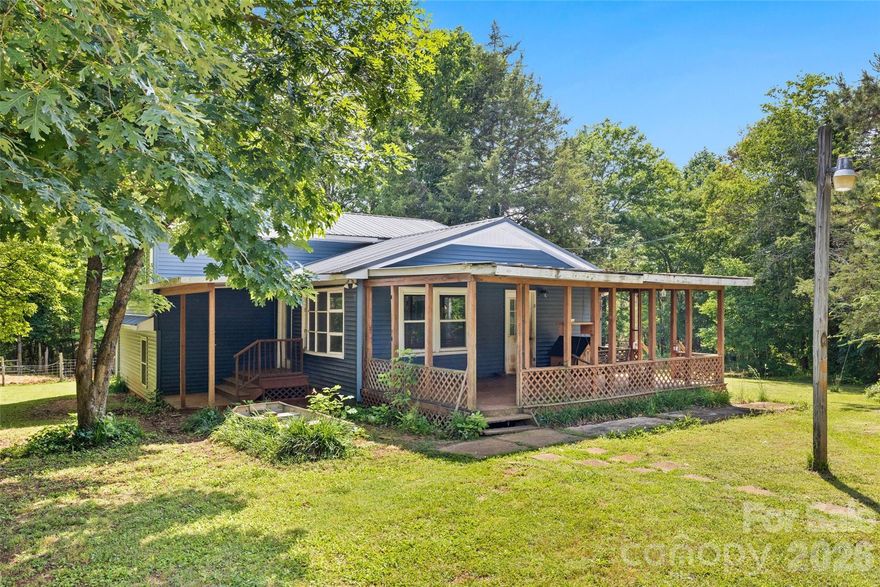 Escape to your own private haven on 11 wooded acres in McConnells! This charming 3-bedroom, 2-bathroom tri-level home perfectly blends rustic country living with everyday functionality. Step inside to discover 1,977 square feet of inviting living space, complete with a cozy wood stove for cold evenings.  The heart of the home is the stunning, fully renovated kitchen (2023), complete with ample counter space for canning your harvest and prepping farm-to-table meals.  The exterior of the home got renovated in 2023 as well with new siding, windows and a French door.
Outdoor living shines with two spacious porches, perfect for enjoying peaceful morning coffee or hosting evening gatherings while overlooking your massive, wooded acreage. The property also features a massive detached 2-car garage providing the ultimate workshop for your tools, feed, and homestead projects. These 11 acres are ready for gardens, livestock, horses or a thriving orchard and on the property you will find fenced areas for animals and a safe poultry coop.  This property has so much potential with room to park outdoor toys as well.  The options are endless!

Oven Range is propane.