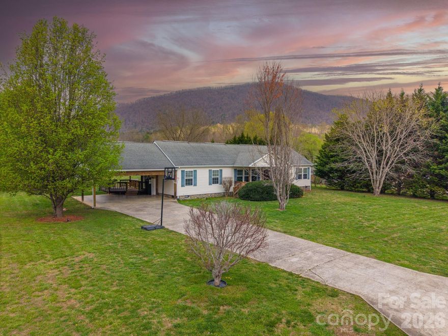 Back on market with a refreshed price and updates underway, making this an even better opportunity to move forward with confidence.

Set on a beautiful, open 0.52-acre lot with mature landscaping and a peaceful mountain backdrop, this inviting home blends comfort, functionality, and privacy. The desirable split floor plan provides separation between living and sleeping areas, while the spacious living room with vaulted ceilings creates an open, airy feel ideal for both everyday living and entertaining.

A versatile bonus den offers flexible use as a home office, playroom, or additional sleeping space. Enjoy the outdoors from the covered front porch or unwind on the private back deck overlooking the fenced yard and surrounding natural setting.

Additional features include covered parking, a storage shed, and a well-maintained setting with no HOA. Conveniently located just a short drive to Marion and Asheville, this home offers both tranquility and accessibility.

With key items already being addressed and additional information available, this home offers a great combination of value and peace of mind before going under contract.