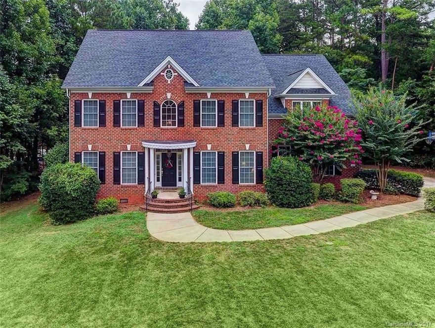Custom FULL BRICK house w/ huge FLAT front yard! REAL oak hardwoods on main. NEW carpet upstairs. Beautiful oversized gas fireplace! Quartz counters, TWO pantries, stainless appliances. SPACIOUS master suite w sitting area, double closet & beautiful NEW glass enclosed shower. HUGE BONUS ROOM perfect for home theater/playroom/game room! Tons of natural light! 2.5 car garage & long flat driveway. Laundry room w sink. Deck w gas grill hookup! Convenient to Lake Wylie, Charlotte, shopping & dining.