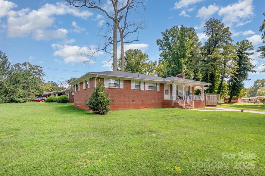 This charming brick ranch sits on a spacious corner lot of nearly half an acre and offers a classic, traditional floor plan. Step into the inviting living room, complete with large picture windows and a cozy fireplace. The bright, open kitchen with adjoining dining area provides convenient access to the carport. The primary suite includes a private bath, while two additional bedrooms and a full hall bathroom complete the main level. The home includes a spacious basement that has been updated with flooring and drywall. While it still needs heating and air, this area—accessible from both inside and outside—offers flexible space for storage, hobbies, or future expansion. Best of all, there’s no HOA!
