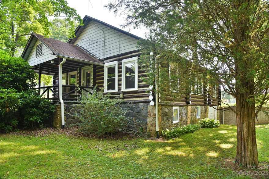 This beautiful 1.28 acre log home is situated in the desirable Candler area, close to the bustling city of Asheville. Situated on a serene and private lot, the home features a hand-crafted log construction, adding natural charm and rustic appeal. A spacious and comfortable interior with beautiful hardwood floors, wood burning stove, perfect for gathering and entertaining. Huge windows letting in plenty of natural light. The front deck deck is a beautiful spot to enjoy the outdoors in solitude or with friends. Perfectly located for a relaxing and tranquil retreat, and just 15 minutes from all the amenities of Asheville.