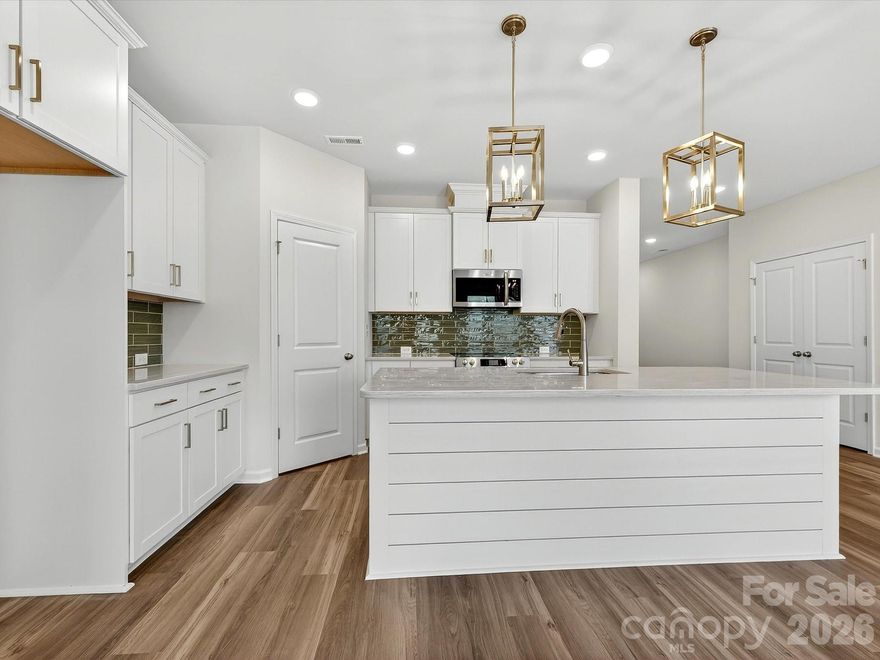 Discover effortless living in the Mecklenburg II, a beautiful new townhome at Westview Towns in Waxhaw, NC. Perfectly situated near the boutiques, restaurants, and small-town charm of historic Downtown Waxhaw, this home offers a low-maintenance lifestyle in one of the area’s most desirable locations.
Step inside and experience open-concept living at its finest. The gourmet kitchen is the centerpiece of the home, featuring luxurious quartz countertops, an oversized island, abundant cabinetry, and designer finishes—a perfect blend of style and function for everyday living or entertaining.
Sophisticated details continue throughout, including elegant wood-tread stairs and large windows that fill the space with natural light. The covered rear porch offers a peaceful spot to relax and unwind, while included lawn maintenance gives you more time to explore and enjoy all that Waxhaw has to offer.
Experience the perfect balance of comfort, convenience, and timeless style in this exceptional end-unit townhome.