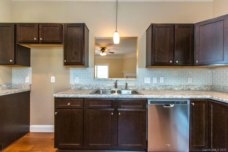 Beautifully renovated 2 Bedrm Townhome + Office/Flex Space. Great room w/Gas-log Fireplace. Gorgeous Kitchen with glass tile backsplash. Private Patio. NEW: windows, upgraded lighting, 30" kitchen cabinets, laminate wood flooring & carpet, s/s appliances, bi-fold doors, and plumbing fixtures including toilets. Crawlspace has new vapor barrier & 6" fiberglass insulation. Mins to Uptwn, 485, 77 & Arsley Shop Ctr. Community Pool/Clubhse! Let's get you sold, moved in + hanging poolside!