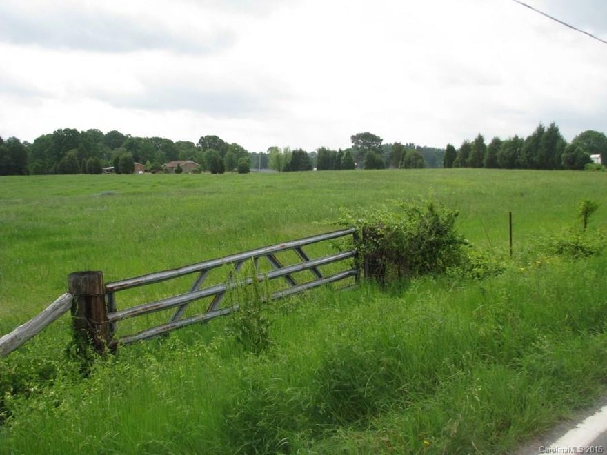 Wide Open Spaces with Multiple Home Sites.  Near Eastview Road Charter School and convenient to shopping or  medical offices/hospital.  Partially fenced and currently being used for quality hay production.  Great paved frontage offers options to divide.