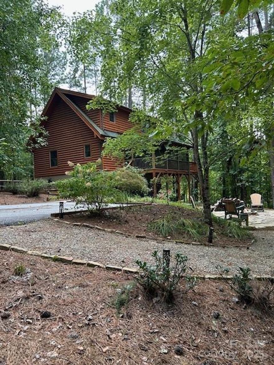 Beautiful Mountain Log Home on 2.5 acres in private Lake Community. 2162 sq ft home, 1372 heated, 789 unfinished. This 2 bedroom, 2 full bath log home is perfect for relaxing & entertaining. Lot includes 150' of lake frontage.  Hidden Lake is a restricted neighborhood featuring paved roads, gated entry, in-ground pool, pier, kayak storage, picnic area and scenic trails. Main level features living area, dining, kitchen, pantry, bedroom and bath - Wood floors, high ceilings and great views from inside or out. Upper floor has sitting area, bedroom, full bath -Great outdoor views. New Heat and Air Feb 2026 Full unfinished basement with access to outside comes with freezer, washer/dryer, dog wash, 2nd dryer, storage shelves - finish as you wish.  Outdoor scenic dining on 2 levels plus covered outdoor dining with grill and large screened in porch overlooking firepit.  
Airports:  Asheville Airport - hour away; Greenville SC & Charlotte 1 1/2 hours.
Rental Restrictions included.