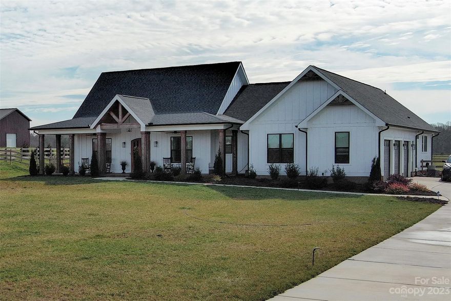 Peaceful country living at its finest in desirable Union County. a blend of rustic charm and modern elegance. As you step onto the property, you are greeted by a serene landscape leading up to a covered front porch that embodies the welcoming spirit of Southern hospitality. Inside, the house features three cozy bedrooms, including a primary bedroom with a full bath, and an additional one and a half baths. The open floor plan is accentuated by a a designer kitchen with a large island, walk-in pantry, SS appliances, and expansive closets, providing ample storage and a sense of openness. Both porches are covered and have stamped concrete. This energy efficient home has a water filtration system and a concrete driveway. The location is unbeatable, nestled in a community served by top-notch schools—Western Union Elementary, Parkwood Middle, and Parkwood High. This home is a sanctuary that combines the peace of the countryside with the convenience of modern amenities.