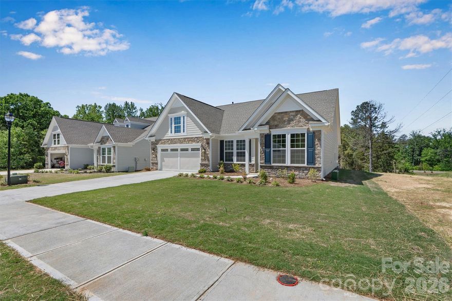 New Construction in the desirable Cresswind community. This stunning 3-bedroom, 2.5-bath Oakside model with a 2-car garage is loaded with designer upgrades from top to bottom. The gourmet kitchen impresses with upgraded cabinetry, quartz countertops, a full-height tile backsplash, and a complete GE Profile appliance suite including a gas cooktop, chimney hood, and wall ovens. The spa-inspired primary bath features a dual-head walk-in shower with a frameless glass enclosure and upscale tile finishes throughout. A butler's pantry, gas fireplace with custom mantel, coffered ceiling, and upgraded crown molding add architectural elegance, while luxury EVP flooring flows seamlessly throughout the main living areas and the Primary bedroom. Step outside to the covered rear porch that extends to a Trex deck with black railing, perfect for entertaining, and enjoy exceptional privacy with no rear neighbors and a tree-lined backdrop. Floored light attic storage, RADIANT BARRIER and premium finishes at every turn make this home truly move-in ready.