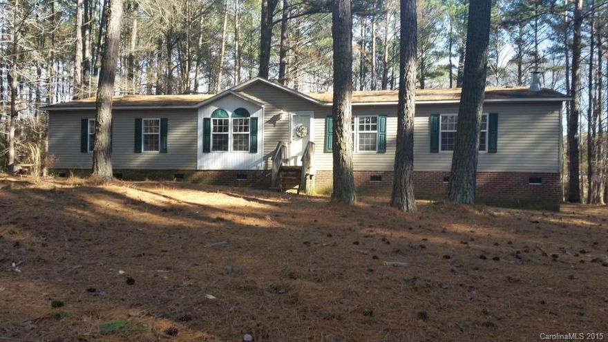 Nestle in the trees on 5 acre lot, pretty double wide features 3 bedrooms, 2 full baths Kitchen/breakfast with island, Greatroom, den and laundry. Garden tub and separate shower in master, all kitchen appliances stay. Large deck on back for outdoor entertaining, Brick underpinning.