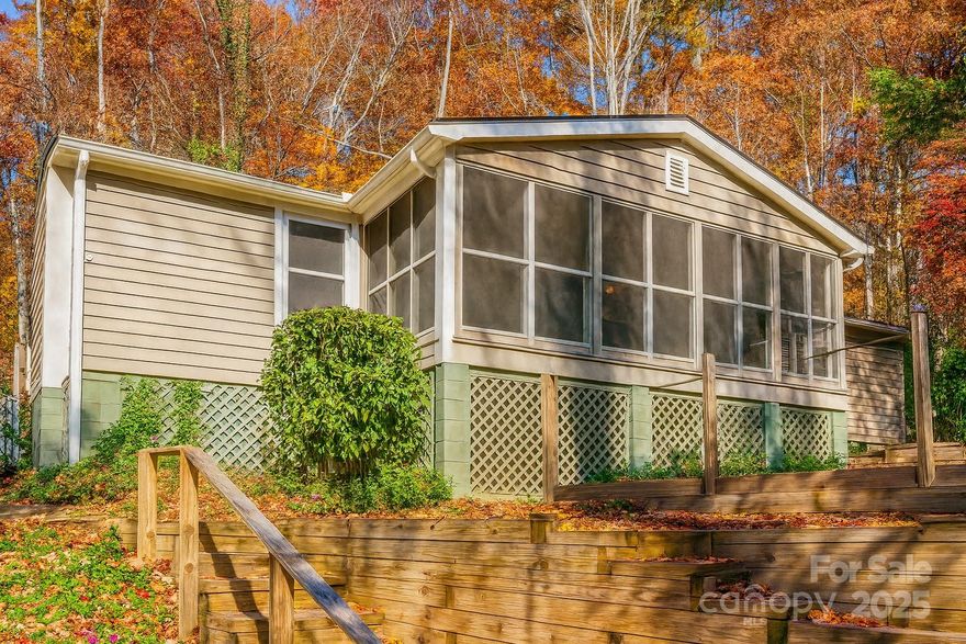 MOVE-IN READY! Discover this charming and totally refreshed 2 bed, 2 bath home perched above the road, offering a treehouse-like feel and exceptional privacy — all just steps from Morse Park, the former Flowering Bridge park, and the Lake Lure Marina! Talk about prime location! Situated on Boys Camp Rd, this home enjoys stunning tree-lined views along with glimpses of the mountains and sparkling water peeking through the trees.

Just minutes away, enjoy a variety of Lake Lure eateries or head 1 mile toward Chimney Rock to explore Chimney Rock State Park, scenic hiking, delicious restaurants, quaint shops, and some of the most breathtaking views the area has to offer.

Inside, you’ll find a roomy primary bedroom, a second comfortable bedroom, and a beautifully updated bathroom featuring a cozy cast-iron clawfoot tub. The gourmet chef’s kitchen showcases an oversized island and stainless steel appliances—including a range, built-in microwave, and dishwasher—making meal prep and entertaining effortless.

This property also shines with its outdoor living spaces. Relax around the extra-large fire pit area, unwind on the oversized screened-in porch with stunning views, or soak up the stunning 360-degree views from the side deck. Take in the mountain vistas and fully immerse yourself in the surrounding flora and fauna from every angle.

This home features a new roof (installed 2025), new floors (2025), newer HVAC (2024), foundation upfits and so much more!

Don’t miss this unique opportunity—a peaceful, private retreat with unbeatable access to Lake Lure’s best amenities, and NO HOA. This quaint hillside cottage with impressive views can serve as your primary residence, weekend getaway, or a fantastic investment retreat. Additional .33 acre parcel behind the property to convey with an acceptable offer.