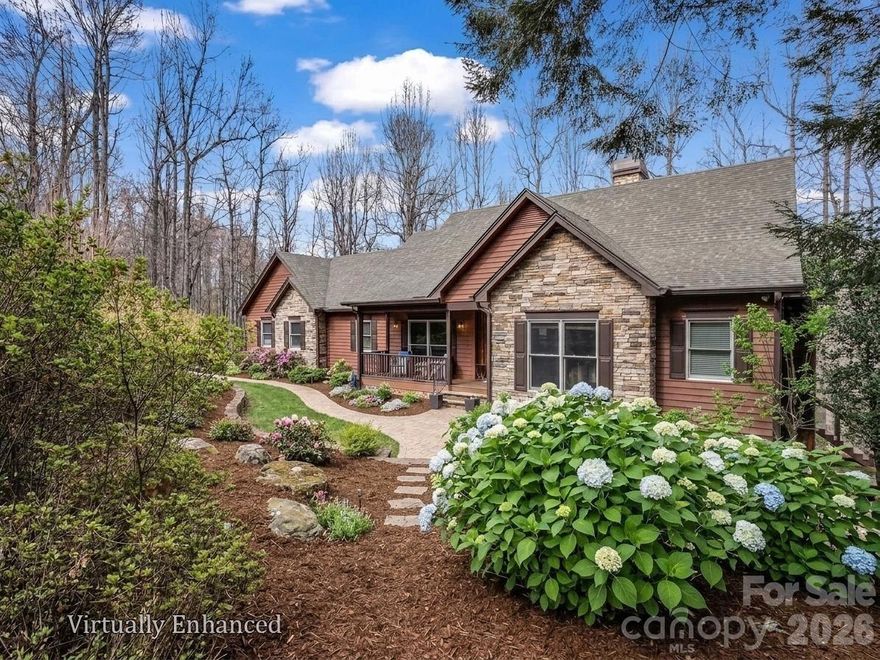 Stunning, well-appointed, pristine home situated in one of the best kept secrets in Hendersonville, Pathways of Solomon Jones, a small enclave of luxury mountain homes within close proximity to Hendersonville and Flat Rock! Pathways of Solomon Jones strives to keep the natural state surrounding its current 43 homes intact, with each having 2 to 5 acres of land, protecting the privacy of its homeowners. This meticulously maintained, 3 bedroom, 3 bath home is set on over 2 acres and is the perfect in size for those wishing to age in place yet have room for family and friends to stay awhile. The main living area has a beautiful, vaulted, beamed ceiling, built in bookcases, and a dramatic, soaring fireplace for cold winter nights. Warm oak floors and new wood doors throughout the main level create that mountain ambiance so many desire. Light streams through its many windows and doors which lead to the large deck with winter views. The gourmet kitchen, featuring high quality cabinetry, leathered granite countertops, double ovens and a walk-in pantry, flows seamlessly into the dining and living rooms making it ideal for everyday living or entertaining. The primary bedroom provides access to the deck as well to take in the surrounding beauty and has an ensuite bathroom with a double leather granite countered vanity, separate shower and garden tub.  The guest bedroom on the main floor could be used as a bedroom or an office, with private access to the second full bathroom, also accessible as a hall bath. The laundry room is also on the main level and offers a sink and pull-down ironing board! Every window beckons one to spend time basking in the magnificent landscaping all around the home with limited grass to maintain. The lower level offers a family room with built-ins for setting up a home office or enjoying a movie. The French Door from the family room provides access to the flagstone patio and paths meandering through the beautifully landscaped flower beds. An additional bedroom, full bath and second bonus room for whatever your heart desires, provide a private oasis for family and friends.  An unheated fitness room is also available for staying in shape from home. And there is plenty of additional unfinished space for one wishing to expand. For those desiring to have access to amenities, guest memberships are available through the Champion Hills and Hendersonville Country Club. A mere 5 minutes down the road is Champion Hills, known for its award-winning Fazio Golf Course, ranked 47th in the US on Golfweek’s 2026 list. Members also enjoy a wellness center, pool, tennis, pickleball, walking trails and upscale and casual dining available through Champion Hills. Hendersonville Country Club is also less than 15 minutes away and offers golf, tennis, pickleball, a pool, fitness center and dining for its members. The charming town of Flat Rock is 17 minutes away. Downtown Hendersonville, just 15 minutes away, was touted by the New York Times as the “City of Four Seasons,” sits on the edge of the Blue Ridge Mountains. It is home to over 200 apple growers with close proximity to world class hiking and bike trails and is known as a quaint, family-friendly town! It was named “Best Retirement Town” in 2023 and continues to attract newcomers both young and old. Hendersonville also offers a variety of medical care options including three hospitals: Advent Health, Pardee Hospital and South Asheville ER. So come and see this home and experience what it feels like to be on vacation all year long!