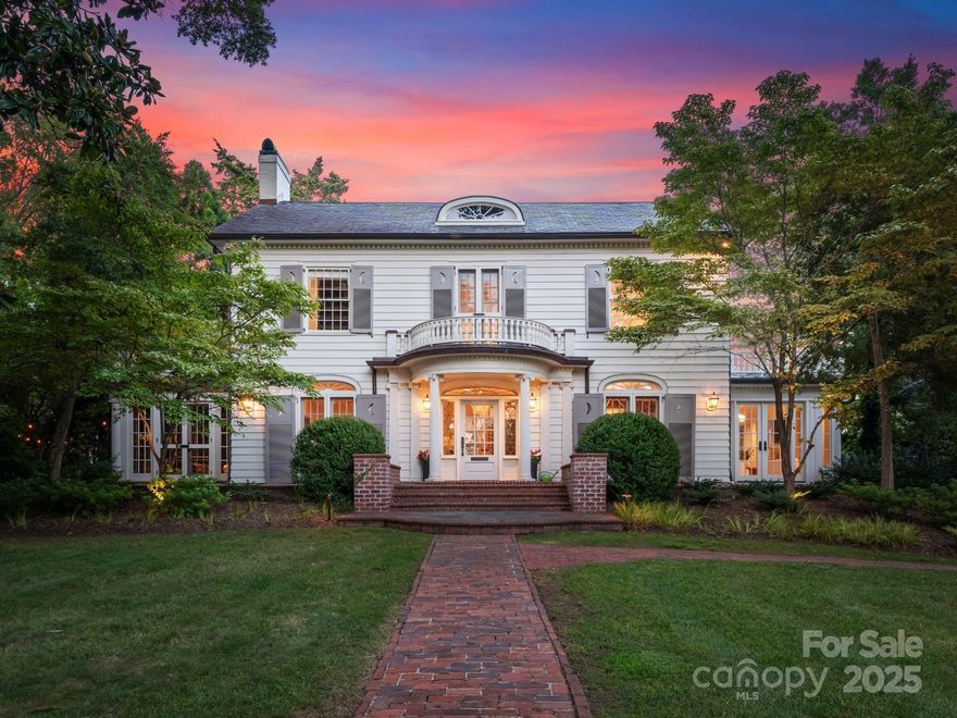 A rare opportunity to own an esteemed Charlotte landmark—this 1987 ASID Designer House and Thomas Moore home artfully blends 1925 Colonial Georgian architecture with today’s modern comforts. Beautifully renovated by Craftsman Construction, the residence is set on a park-like .82-acre lot along Queens Road West. Classic details include a slate roof, neoclassical columns, welcoming front porch, and multiple French doors. Inside, a wide central foyer opens to elegant living and dining rooms, a sun-filled keeping room, paneled study, bar, and third-floor playroom. Two office spaces and a bright kitchen ensure functionality for modern living. High ceilings, intricate moldings, and multiple fireplaces highlight the home’s timeless character. Outdoors, enjoy private gardens with a pond, guest house, pool, and pool house. This landmark residence reflects Charlotte’s heritage while embracing contemporary enhancements in a most prestigious setting!