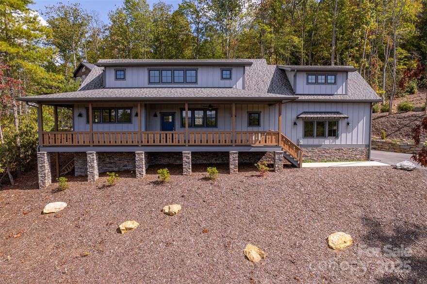 Experience the perfect combination of handcrafted elegance and modern comfort in this newly built Arts and Crafts home! Nestled in the picturesque hills of Fairview just outside of Asheville, this exquisite Arts and Crafts-style residence is a true masterpiece that blends timeless architectural details with contemporary amenities. The exterior is adorned with natural stone accents, wood trim, and a welcoming front porch, while strategically placed windows frame views of the Blue Ridge Mountains from nearly every room and allow natural light to flood the home. Boasting lofty vaulted ceilings, the open-concept great room is anchored by a gas fireplace, creating a cozy focal point for gatherings. Gorgeous, red oak hardwoods flow throughout every room. The design truly reflects the Arts and Crafts philosophy: a handcrafted retreat that celebrates natural materials, thoughtful layout, and a deep connection to the surrounding landscape. This home offers a wonderful opportunity to enjoy luxurious, mountain-inspired living combined with the charm and craftsmanship of an Arts and Crafts masterpiece, all within easy reach of Asheville’s restaurants, amenities, and cultural attractions.