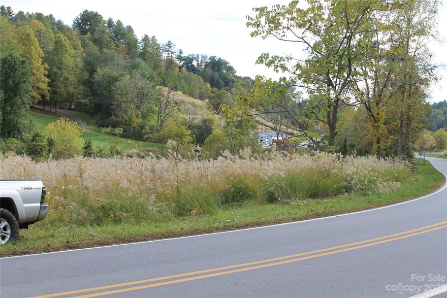 6.65 acres lot on Calvin Edney Road, Mars Hill  is divided in two pieces. There is a Creek front flat land (small meadow) around 2 acres on the right side of the road. This enchanting lot offers a unique opportunity to create multiple dream homes in the heart of the nature with a generous lot size and stunning views of the surrounding mountains and the neighboring pond. This lot features an existing overgrown cut-in driveway. On the top of the ridge are beautiful distant views and various wildlife. Located in the vibrant Mars Hill community, you'll enjoy the perfect balance of rural living and convenient access to local amenities: Mars Hill University, quaint shops, dining options, and recreational activities are all within reach. 12 minutes to downtown Weaverville and 20 to downtown Asheville. Joint lot (935 Calvin Edney Rd, Mars Hill) is also for sale (5.461 acres).