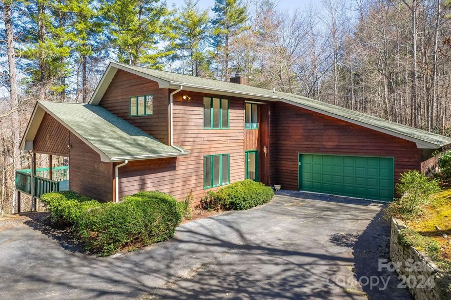 Nestled on a large 2.8+ acre lot, this home boasts 5 bedrooms & 3.5 bathrooms, providing ample space for everyone. The inviting wood siding and picturesque wraparound porch fit in perfectly with the wooded surroundings. The entire home has been freshly painted throughout. The layout connects the kitchen to the dining area, living room, and den, making it ideal for entertaining and family meals. Sellers just installed new carpet upstairs. There are many versatile spaces that can be customized to your needs, whether it be a home office, guest room, or personal sanctuary. The oversized, main-level primary has its own entrance to the back deck. Expansive lot provides endless possibilities for outdoor activities — gardening, enjoying nature, or even fishing with more than 100 ft of private stream frontage. Whether you're hosting a barbecue on the porch or playing in the backyard, this property offers a perfect blend of privacy and outdoor enjoyment. Welcome to your home in Weaverville!