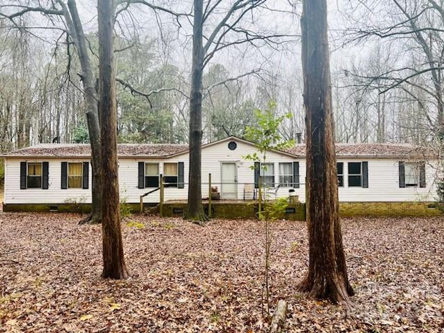 This 4 bedroom, 2 bathroom  home on 4+ acres of land is selling AS IS but has a great split plan floor plan with the potential to shine with some TLC. There is believed to be a second septic tank on the left side of the home where another mobile home used to be. Explore the possibilities of expansion or adding another home on this spacious property. With a little imagination, this property has the potential to become something special. Don't miss the opportunity to create your dream lifestyle. Schedule a showing today! Also listed as LOT MLS 4102061