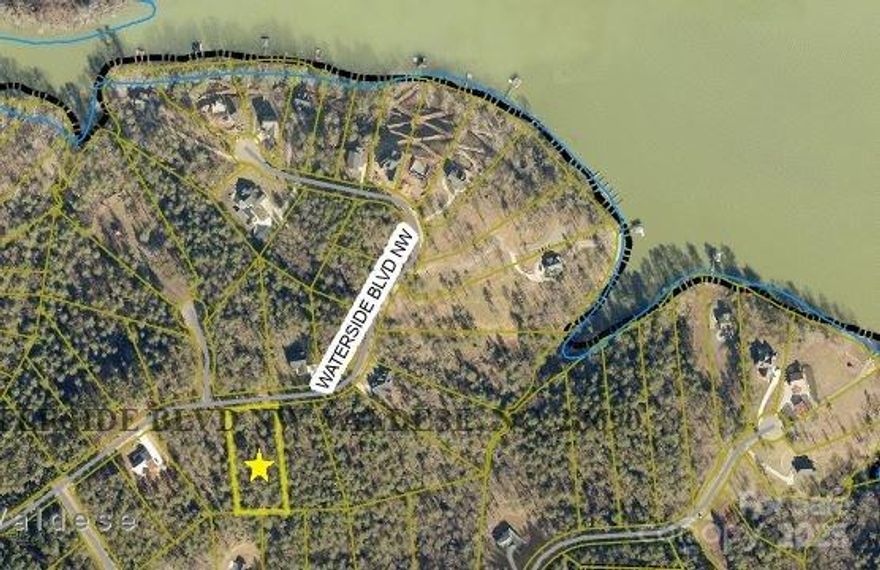 Beautiful 1.26 acre lot in a peaceful, gated waterfront community on Lake Rhodhiss.  Enjoy access to city water/sewer, underground utilities and community amenities including a gazebo, fire pit and grill.  Just minutes from downtown Valdese-perfect for building your dream home.