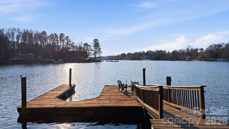 DAILY breathtaking waterfront SUNSETS & NO HOA! Stone steps to private sand beach area & easy level walk to your large private dock with boat slip! This charming beautifully decorated lakefront brick ranch comes with approx. 124 feet of deep-water frontage on LAKE NORMAN with OUTDOOR VIKING appliances INCLUDED! Situated on a partially shaded ½+ acre lot in a quiet no-wake cove w/ large circle drive this 3BR/2BA home gifts you with tranquil outdoor living with a large screened porch, walk-out basement, covered patio, firepit area, hammock, and deck with space for a gazebo. Updated kitchen with stainless steel Viking refrigerator and KitchenAid appliances. Other features include a fireplace in living room and cozy den downstairs with woodstove, rec/office area in fully finished walkout basement with smaller second kitchen, laundry, and additional space ideal for guests or entertaining. Copy of single septic permit page doesn't contain bedroom count. Home is cooled w/ mini splits & Heated w/ mini splits & wall heaters. Preapproved buyers welcome!  Schedule your showing today!