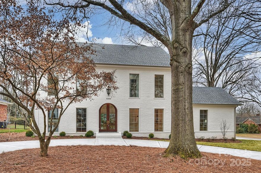 Welcome to 5300 Lansing Drive, a stunning new construction home in Lansdowne. This 5,470 sq ft home boasts 5 BR's, 4.5 baths, & impeccable craftsmanship. Step through handcrafted Sapele wood doors into a sunlit 2-story foyer. The open floor plan features 4" white oak floors, custom millwork, and a chef’s kitchen w/ an oversized island, paneled appliances, quartz countertops, & scullery. The grand great room, w/ soaring 15' ceilings & a Tudor stone fireplace, flows onto a covered porch w/ an outdoor fireplace. The main-level primary suite is a private retreat w/ a floating tub, marble walk-in shower, & dual walk-in closets. The 2nd level offers 4 BR's, a bonus room, flex space, & second laundry, while the 3rd floor provides add'l versatile space. Situated on a flat .44-acre corner lot w/ an attached 2-car garage & in-ground irrigation. Centrally located just 10 minutes from SouthPark, Cotswold, the Arboretum, & Matthews, with quick access to PDS. Experience luxury living at its finest!