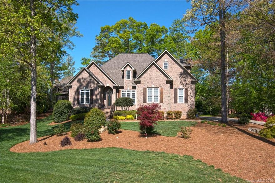 Beautiful custom home nestled in the desired Cowans Ford community with a golf course view. Stunning outdoor oasis with an in-ground swimming pool, hot tub, stone waterfall & spectacular landscaping display. Huge screened porch that overlooks rear yard & is perfect for entertaining. An open plan, high ceilings, granite counter tops, hardwood floors, master bedroom plus second bedroom on main level are a few features that make this elegant home an exceptional find!