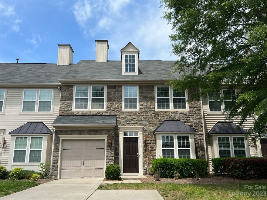 Exterior Stone front 3 bedroom townhome available in Sought after Berewick neighborhood with Resort style amenities. The open and bright floor plan has hardwood floors throughout the entire main level.  The freshly painted kitchen, breakfast area and great room overlook the private fenced backyard.  The kitchen has beautiful 42" cabinetry, Granite counters and Stainless steel appliances.  The separate dining room/ home office has upgraded transom windows. Garage is attached and driveway has space for 2-3 cars(extra parking pad).  Additional visitor parking available. Across the street from the home are the Resort style amenities which include the Manor house, 2 pools, clubhouse, fitness center, sport courts, volleyball, playground, walking trails. pond and more.  The neighborhood is close to shopping, dining, and convenient to Lake Wylie, Charlotte Douglas Airport and Uptown.