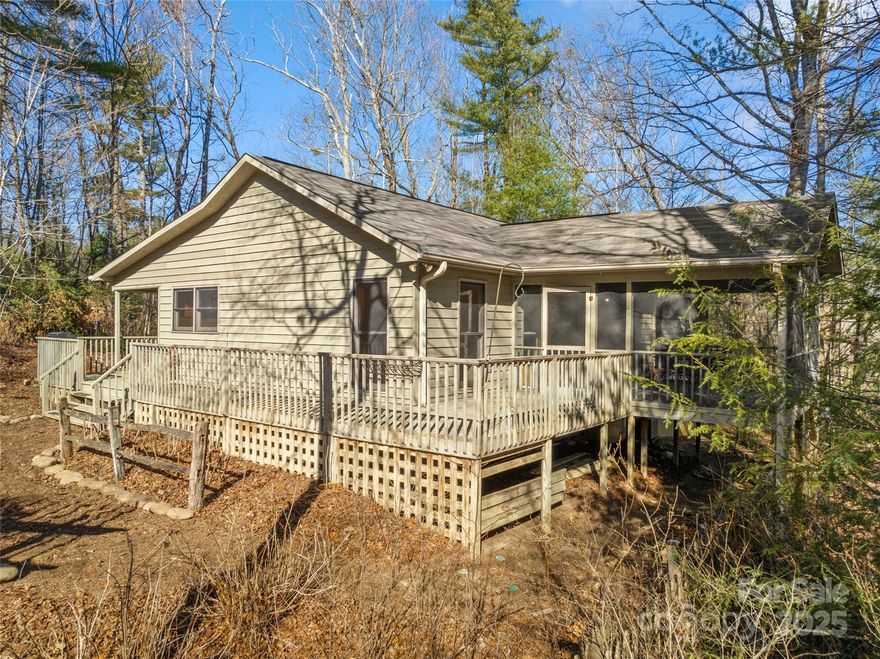 Welcome to your very own serene retreat in the heart of Winfield Cove! This charming 2 bed, 2 bath, and an additional 2 flex space room, home is a perfect blend of comfort & nature, sitting on a beautiful 5.12 acre lot. The split bedroom floor plan offers a private master suite, with its own screened porch. One flex room has a built-in bookcase wall with a designated desk area, great for a home office or study, the second flex area is for your personal needs: nursery, workout space, craft room, etc.

The vaulted living room visually expands into the large screen porch sitting high with more sights and sounds of nature.  On the entry side of the house, coming from the wrap around deck, is a screened porch running the length of the house. 

This cabin-style gem, with a whole house generator, is offering a peaceful lifestyle just a short drive away is nature and adventures in state and national park lands, water sports, hiking, ziplining, waterfalls are just a start.