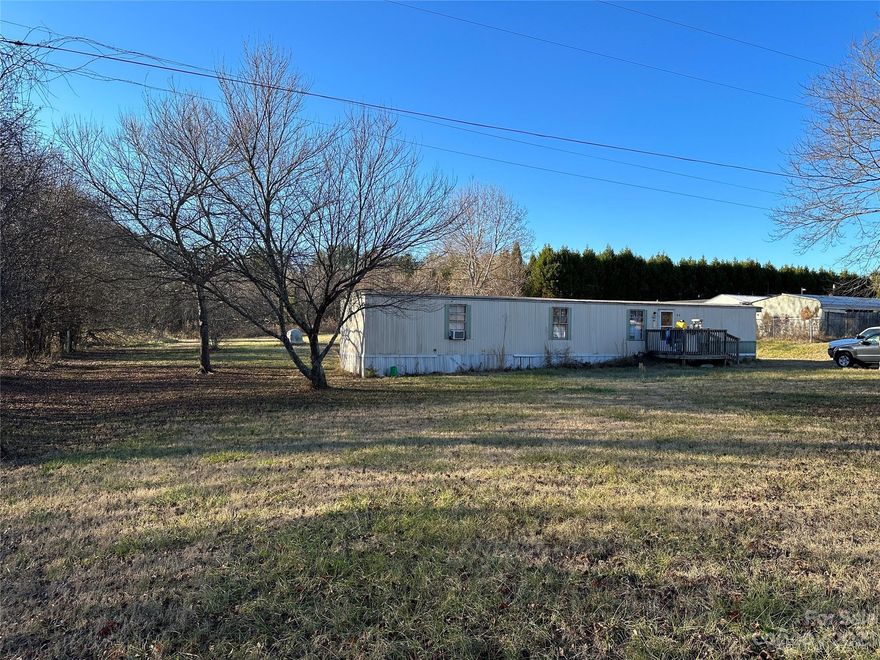 1.21 acre lot with well and septic in place. Mobile home is listed as having "no value" due to damage inside and out. Additional lots available beside this lot.