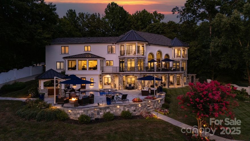 Set against the stunning backdrop of Lake Norman, 140 Larkhaven Lane offers an exceptional waterfront lifestyle. This exquisite residence features spacious, light-filled interiors with captivating lake views from nearly every room. Inside, refined finishes and meticulous craftsmanship create a warm and welcoming ambiance. Outside is your private backyard sanctuary featuring a shimmering pool, fully equipped outdoor kitchen, and tranquil koi pond—perfect for peaceful relaxation or lively gatherings. The impressive double-decker dock provides an unparalleled vantage point for morning coffee, breathtaking sunsets, or embarking on your next lake adventure. Conveniently located just minutes from Mooresville’s vibrant amenities and a short drive from Charlotte, this home blends comfort, privacy, and the quintessential lakefront lifestyle.