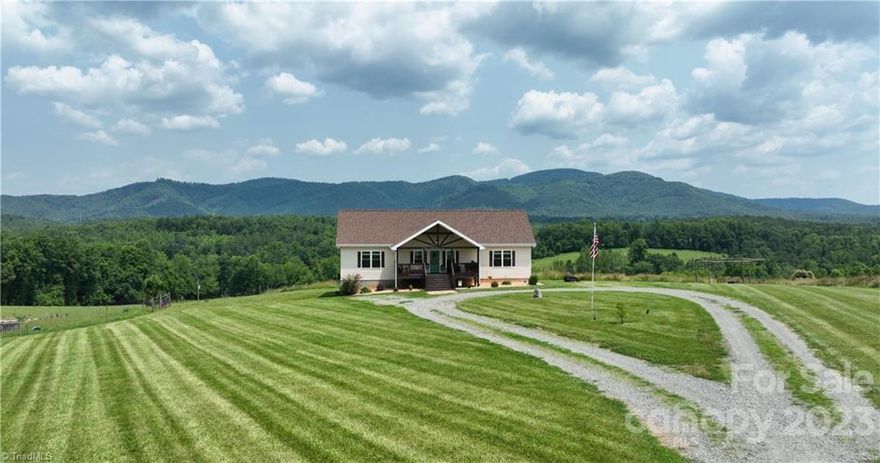 Captivating Mountain Views that inspire serenity. With its exquisite design, seamless integration with the surroundings, this residence is a haven for those seeking solace and connection with nature. The design concept effortlessly blends contemporary aesthetics with cozy mountain charm, resulting in a space that feels both sophisticated and welcoming. Hardwood floors throughout, tile floors, granite counters, stainless appliances, loft/bonus room. Full unfinished basement with garage. Large deck overlooking unsurpassed views with room to roam the 8.4 acres of rolling pastureland. A short drive to Stone Mountain Park and Stone Mountain Golf Course