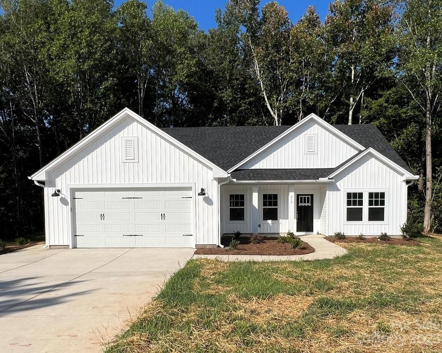 NEW CONSTRUCTION IN TROUTMAN ON BEAUTIFUL .5 LOT! $2,500 in closing cost credit with accepted offer.  Brand new ranch/ farm house style home with upgrades galore! Home features an open floor plan with drop zone off garage entrance. Large kitchen with lots of cabinet storage, island with room for seating, quartz countertops, stainless steel appliances, subway tile backsplash and walk in pantry. Large concrete patio and wooded backyard. Master suite boasts large walk in closet, double sink quartz vanity with tile shower walls. Features two additional bedrooms, hall bathroom with quartz countertops. Many upgraded builder features as well as engineered vinyl plank flooring through main body of home. Situated perfectly in the town of Troutman on quiet road cul-de-sac street, while still minutes from I77 & the heart of downtown Troutman.