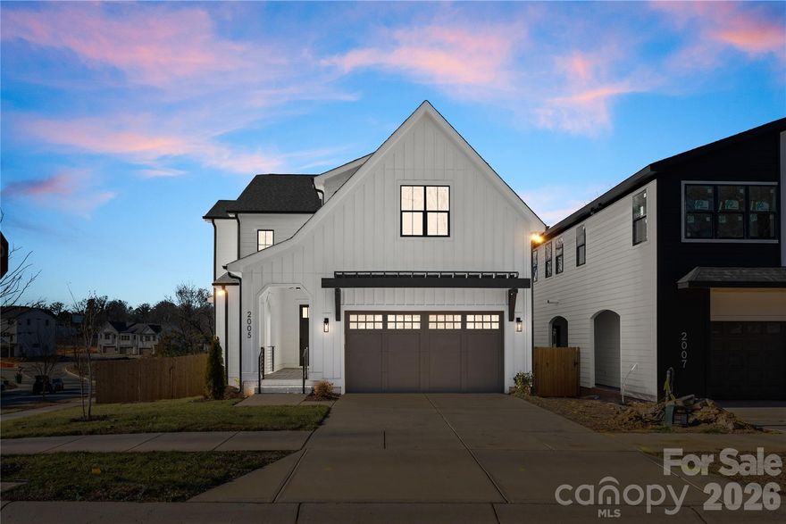 Welcome to this thoughtfully designed new construction home in Enderly Park, just minutes from Uptown Charlotte and the airport. A grand entryway with soaring ceilings sets the tone, while the open layout and catwalk overlook create a light, airy feel throughout.

The main level offers a dedicated office, a functional mudroom with additional storage, and a finished two-car garage with epoxy floors. At the center of the home, the chef’s kitchen shines with an oversized waterfall island, expansive cabinetry, stainless steel appliances, and a walk-in pantry with hidden storage. The kitchen opens seamlessly to the living room, where a fireplace with built-in storage anchors the space—perfect for both entertaining and everyday living.

Upstairs, enjoy a cozy loft, a spacious walk-in laundry room, and four generously sized bedrooms. The owner’s suite serves as a true retreat, complete with a custom walk-in closet and a spa-inspired bath. The oversized fourth bedroom offers exceptional flexibility and can easily function as a bonus room, media space, or secondary living area.

Situated on a corner lot, this home features a private fenced backyard and deck ideal for relaxing or hosting guests. With modern finishes, thoughtful design, and a prime location, this home offers a refined take on Enderly Park living.