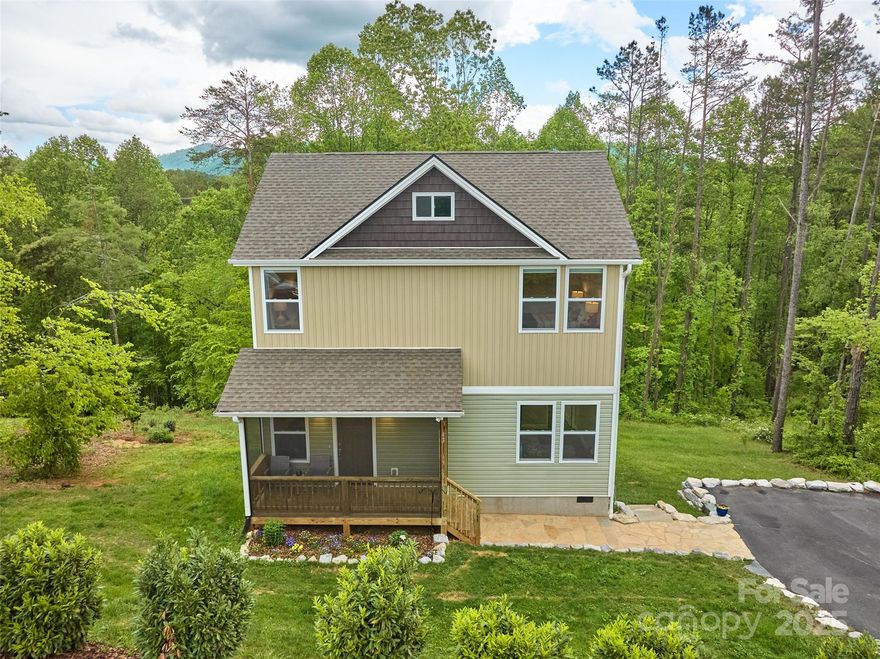 Enjoy peaceful mountain living in this well-maintained home, minutes from downtown Weaverville. Nestled on an acre with winter mountain views, this move-in-ready property offers both serenity and convenience. Embrace indoor/outdoor life with a covered, screened front porch, screened back deck, and expansive backyard—ideal for entertaining. Well-designed main level features a cozy living room that flows into a kitchen appointed with granite and stainless steel. Bright, main-level primary suite boasts a walk-in closet with stylish barn door and a full bathroom. Upstairs landing is perfect for an entertainment area. Two additional bedrooms, a full bath, and a convenient laundry room are also upstairs. Excellent proximity to downtown Asheville, Mars Hill, Marshall, and the June Bug Retro Resort; easy interstate access. Beautiful landscaping with boulder accents, a stone walkway, and a harmonious blend of new and mature greenery completes this exceptional property. See brochure for details.