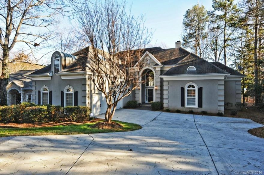 Elegant hard coat stucco home on the golf course with OUTSTANDING lake and golf course views! Master suite with hardwood floors, updated master bathroom with steam shower and a guest suite with full bath all on the main level. Arched doorways, screened porch, and circular driveway on a cul-de-sac lot.