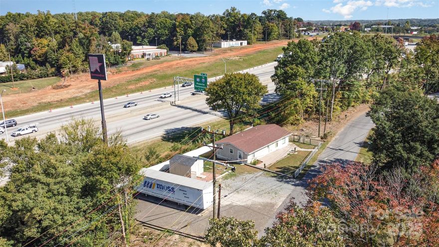 Position your business for success in this fully renovated 1,305 sq ft flex property, ideally situated near I-85 and Sam Wilson Road in Charlotte’s thriving west side. This prime location offers exceptional visibility and accessibility, just minutes from Charlotte-Douglas International Airport and multiple Amazon distribution centers — a strategic hub for logistics, service operations, or last-mile delivery. The building features new roof, plumbing, and electrical systems, along with a refreshed kitchen/breakroom and defined office space ready for immediate use. With parking available for company vehicles, natural gas service, and easy interstate access, this 0.19-acre site provides the perfect foundation for light industrial, storage, or service-based operations. A rare opportunity to own a business-ready property in one of Charlotte’s most connected commercial corridors!