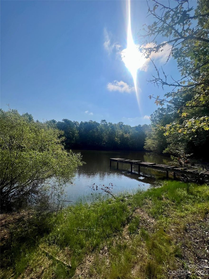 A remarkable 60-acre property offers a range of possibilities, mini farm, family compound, private estate, large or small subdivision. Embrace the essence of rustic country charm while enjoying the convenience of nearby city amenities. Enjoy the serenity provided by the lush trees, natural surroundings, and abundant wildlife. Spend leisurely days by the creek or enjoy fishing or swimming in the pond. Situated in the Indian Land School District, this property features rolling hills, pastureland, and scenic riding trails along the banks of Sugar Creek. An existing cabin with a dock adds to the property's allure, providing potential for a weekend getaway or a permanent residence post-renovation. Explore the owner financing possibility, offering an enticing rate of 3.75%, (subject to seller approval). Take advantage of the benefits associated with low South Carolina taxes and the close proximity to shopping, dining, the proposed new MUSC Hospital, and the anticipated new Costco.