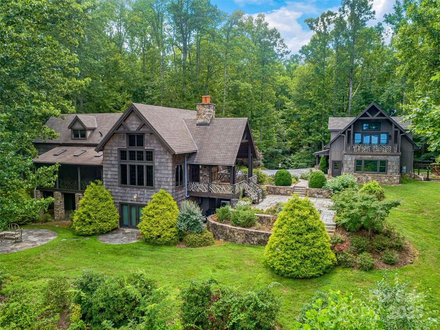 Welcome to 5019 Willow Road, a stunning 7.27-acre estate offering privacy, breathtaking long-range mountain views, and a peaceful retreat just 15 minutes from downtown Hendersonville and just outside the prestigious Champion Hills Country Club. This meticulously crafted home boasts an impressive custom design, with expansive windows showcasing panoramic views. Enjoy the serenity of 2 ponds with dock, and walking trails throughout the lush grounds. The large, level yard offers endless possibilities—whether you're envisioning a swimming pool, tennis court, or elegant garden escape. Inside, the main house features hand-painted walls, oak hardwood floors, reclaimed wood beams, and exquisite poplar leaf accents. Entertain in the gourmet kitchen. Thermador appliances. 3-car garage includes an apartment with a mountain-facing porch. Relax on the open-air patios or in the spacious primary suite with a luxurious bath. Magnificent sunset views await at this one-of-a-kind mountain estate!