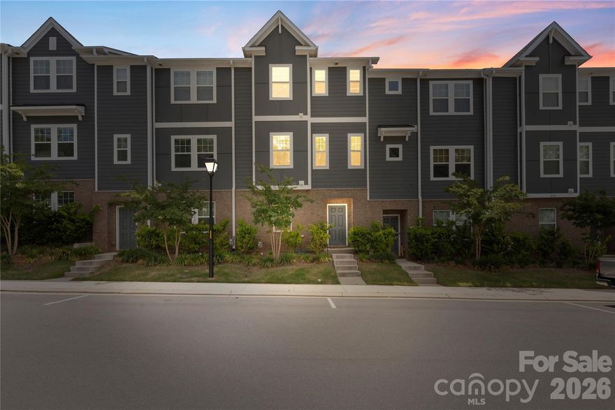 Modern 3-story townhouse built in 2022 offering 4 bedrooms and 3.5 bathrooms with a stylish and functional layout. This like new home features a guest/second primary suite on the main level which can also make for a quiet and private office location sharing the level with just the 2 car garage! The second level showcases a wide open floor plan with a bright living room, dining area, and a sleek kitchen with a large island, gas cooktop, walk-in pantry, stylish pendant lights, quartz countertops and modern appliances. The second level is complete with the private balcony, perfect for quick fresh air, or enjoying your morning coffee outside. The third level includes the spacious primary suite boasting custom shelving in the walk-in closet and private bath complete with dual vanity and tile surround shower. The two additional bedrooms offer additional living space, or provide great space for hobbies, gym equipment or additional office space if needed.  Additional highlights include laminate wood flooring, drop zone, tankless water heater, and a 2-car rear-entry garage. Ideally located just 10 minutes from Uptown Charlotte, and close proximity to Renaissance Park and the Charlotte Regional Farmers Market. With easy access to I77, I85 and CLT airport this home checks all the boxes for a modern Charlotte lifestyle