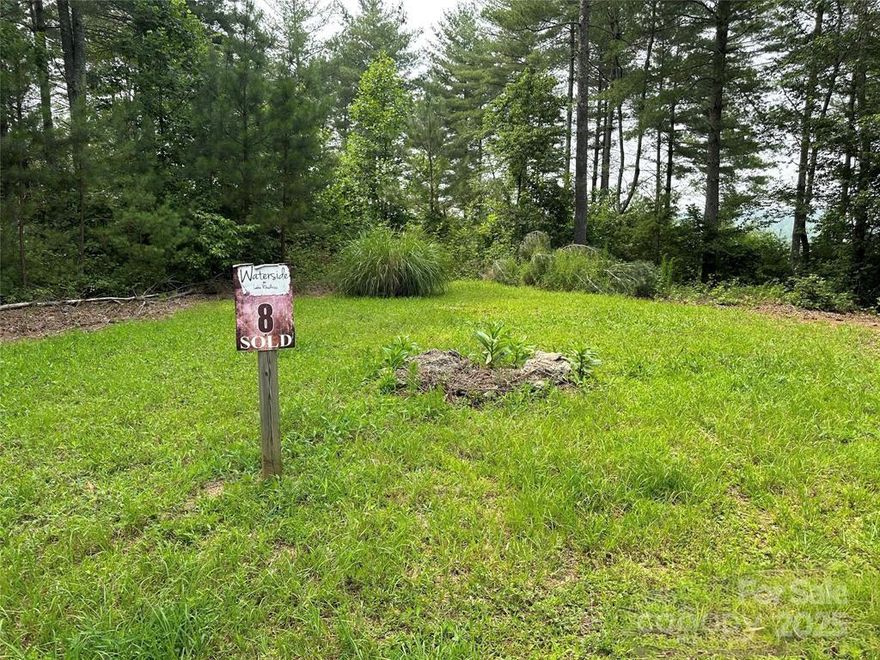 Lake views without the lakefront price! This lot nestled in a peaceful cul-de-sac in the Waterside neighborhood on Lake Rhodhiss is a beautiful area to build your dream home - or a home away from home! With a minimum footprint of only 1,400 square feet required to build, this lot can accommodate either. With some strategic tree removal, this piece of land could yield some gorgeous views of the western end of Lake Rhodhiss in the foreground and the Appalachian Mountains in the distance. HOA dues are currently just $300/year. Golf carts and UTVs (muffled appropriately) are allowed within the neighborhood, and the development features include underground utilities, city water, city sewer, community park with community outdoor firepit, gazebo, and grill. There is also a community boat dock with slips available and leasing for just $500/season! Don't wait around on this!