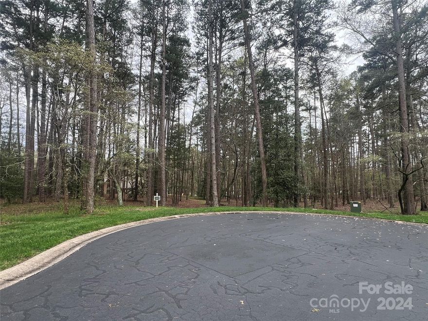 Build your dream home on this .87 acre lot in the prestigious gated community of Uwharrie Point! This community offers membership to the Old North State Golf Club where you can enjoy golf, tennis, swimming, fitness, dining and a full-service marina.  The neighborhood has a 24-hour guard gate, providing you extra security.  There is county water and sewer available (tap fee required). Make this cul-de-sac lot the location of your dream home today!