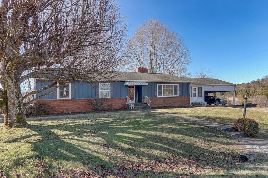 This classic ranch has been lovingly updated and boasts many high end, contemporary finishes; granite counters, barn wood accent walls, a new huge back deck, built in storage and ect. this home has it all.
A 20 minute drive to downtown Asheville, it is located right off I 40 exit 33.
The living room and eat in kitchen are massive! There is great outdoor living on both levels. The home also features a very functional and good sized yard. 
The primary is connected to the main level bathroom giving en-suite access. The home office is on the opposite end from the bedrooms and right off of the kitchen allowing for focus and productivity.
The basement also has a full bath and is a world of potential living space. It has tons of storage there are built in cabinets and a separate cellar room.
Very reasonably priced this house cant wait for you to call it home!