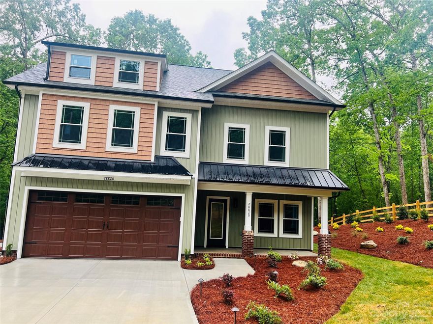 NEW CUSTOM HOME with 2-tier paver patio, fire pit & great view of babbling stream / HARDWOOD FLOORS THROUGHOUT THE ENTIRE HOME (1ST & 2ND FLOORS). Rock steps to creek + Outdoor Lighting / Sod yard / Fence front and side yard & shared entry / Gutters with GUTTER GUARDS Buried and Piped away from home, sewer pump installed / Interior Shiplap Decor Electric FP with blower & cedar mantle / Cedar beams on ceiling / Floating cedar shelving in laundry room / double hung windows.  7' Tall front & back doors.  Kitchen has under counter lighting.  Backsplash in kitchen, laundry & pantry.  Kitchen has white shaker cabinets & granite countertops + Farmhouse Sink / Walk-in Pantry has Gray shaker cabinets / Upgraded black plumbing faucets throughout entire house.  Tile shower in master + glass door.  Metal roof on front of house (porch & garage section decor).  Upgraded lighting package. Large 36" double door closets in bedroom #2, 3 & 4.  Craftsman style trim entire home. Pulldown stairs to attic.