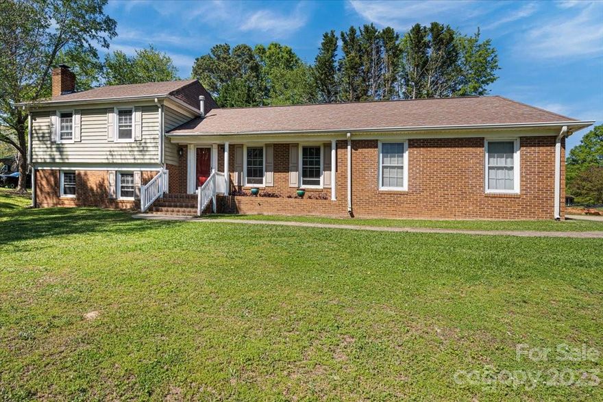 Charming split level 4 bedroom 3 bath brick home close to Monroe hospital, highway 74, Lowe's and so much more. Located in Lakeview estates!  Beautiful, oversized corner lot!  Newer laminate flooring on main and lower levels.  Living Room on main level and Den on the lower level offering plenty of room for everyone! HVAC and roof 2016, water heater 2022 and has a transferable warranty. Chimney sweep recently done and works great. Wood on the side of home is free and stays with the home! Home being sold as-is! Address may also come up as 1407 Lakeview Drive. 8x8 shed coveys. Ample parking with 2 car garage and additional parking in driveway.