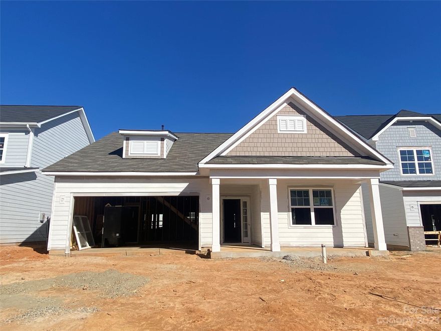 Located minutes from Reedy Creek Park, this 1.5 story home faces west & has sunny and spacious living space. The Kitchen overlooks the Dining & Family rooms, which have a vaulted ceiling and lead to the Sunroom and rear covered porch. The Kitchen features 42" white perimeter cabs w/ light gray painted cabs at the island, GE SS Profile app w/ 36" gas cooktop, chimney extraction hood vented outside, wall oven & microwave, double trash pullout, drawer stack, quartz counters, tile backsplash, large stainless steel single bowl sink and Moen brushed gold faucet. First-floor Premier Suite has a tray ceiling; bath has light gray painted cabs, quartz counters, large tiled shower w/ semi-frameless glass enclosure, shampoo niche, tiled floor. Second floor offers a Rec Room, secondary bedroom and bath. Secondary baths both have quartz counters, white cabs, tiled floor; Bath 2 has a steel tub with tiled walls. Nice sized mud & laundry rooms. Oak treads on stairs. Easy access to I-485!
